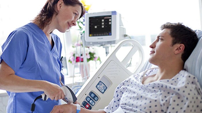 Un clinicien souriant a un patient sur un lit
