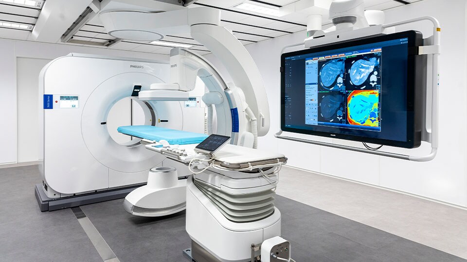 Photo of clinicians conferring about CT results on a computer monitor