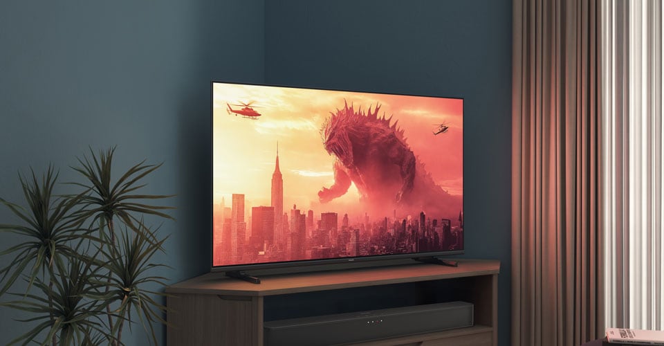 Un téléviseur Philips sur un support d'angle affiche un film Godzilla