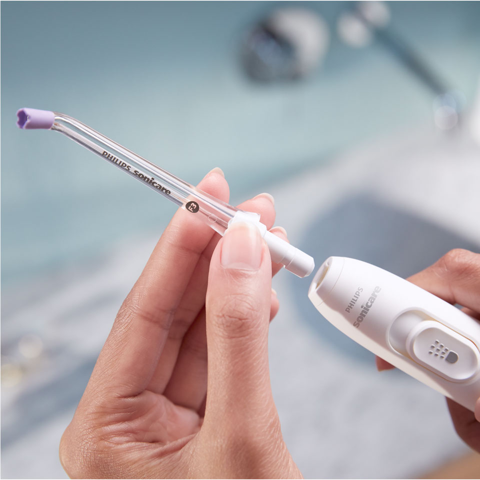 Main fixant une canule Quad Stream sur le Power Flosser